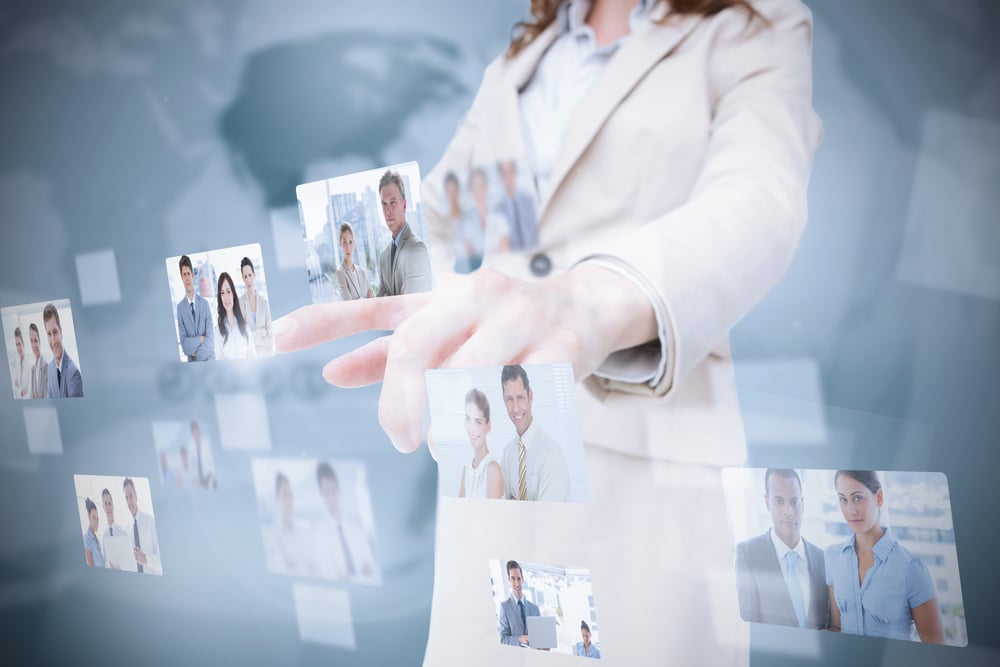 Stylish businesswoman presenting coworkers pictures on digital interface